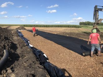 Carbon-rich wood chips will break down nitrates in the water before it reaches the system outlet. Photo credit: Matthew Helmers, ISU Director of the Nutrient Research Center